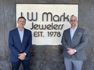Bradley Marks (left) and Landon Aune (right) in front of I.W. Marks Sign